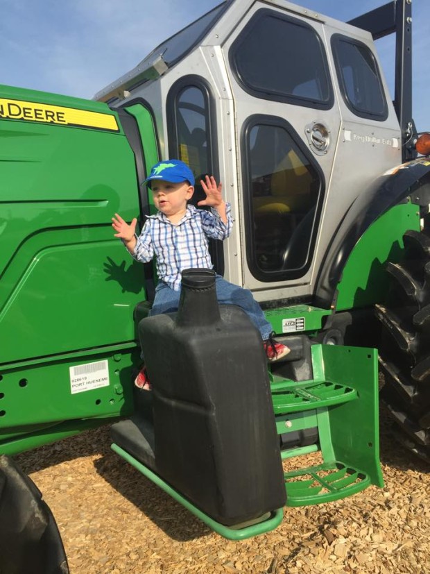 Hey kid, that's not how you ride a tractor. Stop having so much fun!